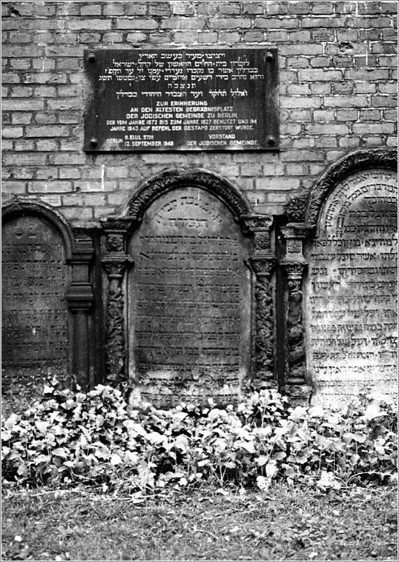 Ancient gravestones and a memorial plaque in the Jewish cemetery on Grosse Hamburger Strasse in Berlin